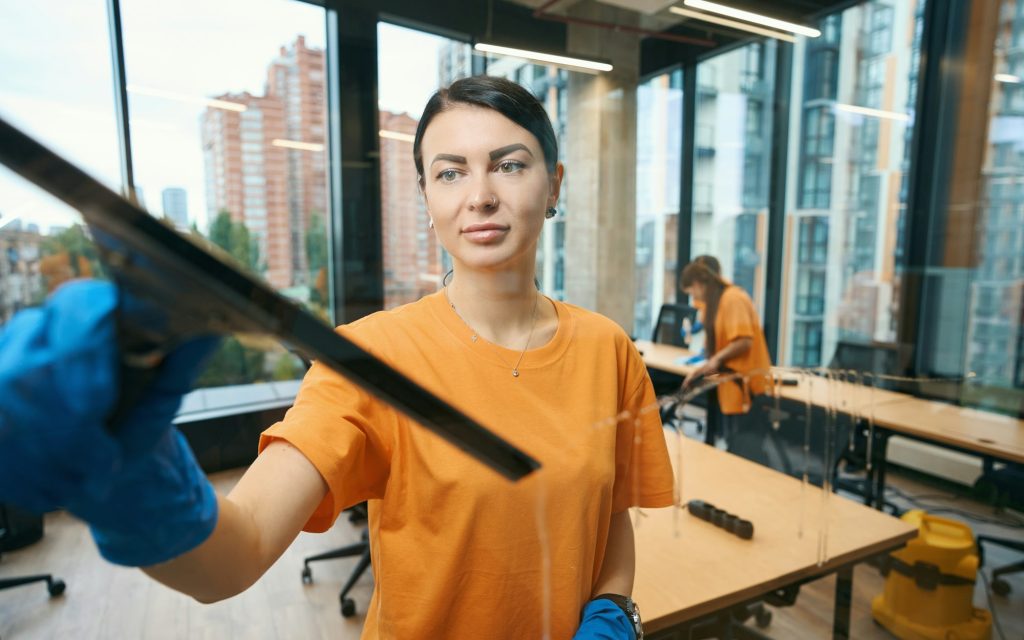 Cleaning company workers use different gadgets while cleaning and disinfecting